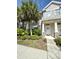 Charming townhome with manicured landscaping and inviting front entrance, enhanced by elegant stone accents and palm trees at 12334 Country White Cir, Tampa, FL 33635