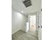 Bright hallway with light wood-look floors leads to various rooms at 12334 Country White Cir, Tampa, FL 33635