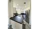 Modern kitchen with stainless steel appliances, black countertops, and ample cabinet space at 12334 Country White Cir, Tampa, FL 33635