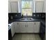 Modern kitchen features stainless steel sink, sleek white cabinets and under-cabinet lighting at 12334 Country White Cir, Tampa, FL 33635