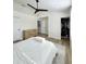 Primary bedroom with a ceiling fan, wood-look floors and a walk-in closet at 12334 Country White Cir, Tampa, FL 33635