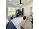 Bright office space featuring a ceiling fan, shelving, and a large window with a lush green view at 12334 Country White Cir, Tampa, FL 33635