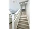 Bright, wood-look staircase with white risers and railing ascends to the second floor at 12334 Country White Cir, Tampa, FL 33635