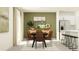 Dining room with a dark table, modern light fixture, and open connection to the kitchen at 13147 Empress Jewel Trl, Parrish, FL 34219