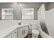 Clean and tidy bathroom with white fixtures, vanity, toilet, and shower/tub combo at 1459 Joel Ln, Clearwater, FL 33755