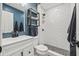 Stylish bathroom featuring white subway tile shower, blue accent wall, and modern fixtures at 1459 Joel Ln, Clearwater, FL 33755