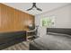Modern bedroom with wood accent wall, sleek dresser, and dedicated workspace by the window at 1459 Joel Ln, Clearwater, FL 33755