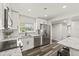 Modern kitchen features sleek stainless steel appliances and bright white cabinets and countertops at 1459 Joel Ln, Clearwater, FL 33755