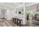 Modern open-concept living room with island, dining area, and access to a sunroom at 1459 Joel Ln, Clearwater, FL 33755