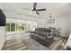 Open concept living room featuring modern furniture and access to a sunroom at 1459 Joel Ln, Clearwater, FL 33755