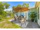 Outdoor patio with seating area, umbrella, grill, and a lush green landscape at 1459 Joel Ln, Clearwater, FL 33755
