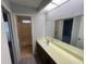 Bathroom featuring single vanity, long mirror, and tub shower at 14725 Morning Dr, Lutz, FL 33559