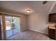 Dining area with carpet, a sliding glass door and views of the screened porch at 14725 Morning Dr, Lutz, FL 33559