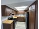 Functional kitchen featuring wood cabinets, modern appliances, and a bright skylight at 14725 Morning Dr, Lutz, FL 33559