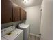 Small laundry room with washer and dryer and some upper cabinet storage at 14725 Morning Dr, Lutz, FL 33559