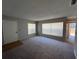 Bright living room with neutral carpet, big windows and natural light and a door to outside at 14725 Morning Dr, Lutz, FL 33559