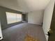 Bright living room featuring neutral carpet, freshly painted walls, and large windows at 14725 Morning Dr, Lutz, FL 33559