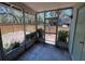 Enclosed screened porch overlooking the fenced backyard with room for outdoor seating at 14725 Morning Dr, Lutz, FL 33559