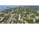 Aerial view of neighborhood and location of home, surrounded by mature trees at 1516 Santa Anna Dr, Dunedin, FL 34698