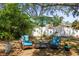 Outdoor backyard features seating, an umbrella, and landscaping at 1516 Santa Anna Dr, Dunedin, FL 34698
