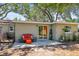 Outdoor space featuring a charming patio with seating, plants, and sliding glass doors for seamless indoor-outdoor living at 1516 Santa Anna Dr, Dunedin, FL 34698