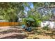 Lush backyard featuring an outdoor seating area, bamboo and wood fence at 1516 Santa Anna Dr, Dunedin, FL 34698