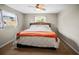 Comfortable bedroom with ceiling fan, natural light, and neutral color scheme at 1516 Santa Anna Dr, Dunedin, FL 34698