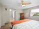 Cozy bedroom features a ceiling fan, closet and a convenient bathroom entrance at 1516 Santa Anna Dr, Dunedin, FL 34698