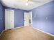 Bright blue bedroom featuring a closet and an entrance to the ensuite bathroom at 1516 Santa Anna Dr, Dunedin, FL 34698