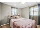 Bedroom with a bed, neutral paint, and two windows at 1516 Santa Anna Dr, Dunedin, FL 34698