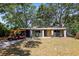 Charming single-story home featuring a well-manicured lawn and a delightful golf cart at 1516 Santa Anna Dr, Dunedin, FL 34698