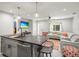 Open kitchen with stainless steel appliances, island, and stylish pendant lighting at 1516 Santa Anna Dr, Dunedin, FL 34698