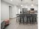 Well-lit kitchen featuring a center island with bar stool seating and modern stainless steel appliances at 1516 Santa Anna Dr, Dunedin, FL 34698