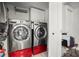 Laundry room featuring a modern washer and dryer with cabinet storage at 1516 Santa Anna Dr, Dunedin, FL 34698