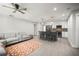 Bright open-plan living and kitchen area with modern cabinets and a cozy gray couch at 1516 Santa Anna Dr, Dunedin, FL 34698