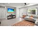 Bright open living room with stylish furniture and a large flat-screen TV at 1516 Santa Anna Dr, Dunedin, FL 34698