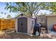 View of the outdoor storage shed, complemented by a nice grill and adjacent to outdoor seating area at 1516 Santa Anna Dr, Dunedin, FL 34698