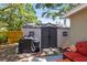 Outdoor storage shed that is complimented by a nice outdoor seating area and grill at 1516 Santa Anna Dr, Dunedin, FL 34698