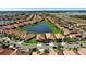 Community aerial view of homes, ponds, and greenery, creating an inviting neighborhood at 16913 Anchor Root St, Wimauma, FL 33598