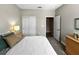 Bedroom featuring a cozy bed, closet, and entry to the bathroom at 16913 Anchor Root St, Wimauma, FL 33598
