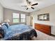 Cozy bedroom features plush carpet, a view of the lake, and ample natural light at 16913 Anchor Root St, Wimauma, FL 33598