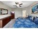 Comfortable bedroom with plush carpet, ceiling fan, and ample storage space with dressers at 16913 Anchor Root St, Wimauma, FL 33598