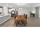 Open floor plan with a dining room and kitchen featuring wood flooring and a wooden table at 16913 Anchor Root St, Wimauma, FL 33598
