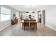 The dining area showcases wood floors, a wooden table, and an open view into the kitchen at 16913 Anchor Root St, Wimauma, FL 33598