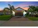 Charming home featuring a paver driveway and well-maintained landscaping, perfect curb appeal at 16913 Anchor Root St, Wimauma, FL 33598