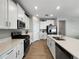 Beautiful kitchen with white cabinets, stainless steel appliances, and quartz countertops at 16913 Anchor Root St, Wimauma, FL 33598