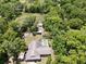 Breathtaking aerial view of the house with an expansive yard, pool, and lush greenery at 17830 Simmons Rd, Lutz, FL 33548