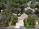 Aerial view of a landscaped property featuring a pool, a detached garage, and a sprawling canopy of mature trees at 1799 Dixie Hwy, Tarpon Springs, FL 34689
