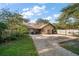 Large backyard with gravel parking area, partially fenced and landscaped with mature trees at 1799 Dixie Hwy, Tarpon Springs, FL 34689