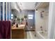 A bathroom featuring a vanity with floral wallpaper and a shower with a curtain at 1799 Dixie Hwy, Tarpon Springs, FL 34689